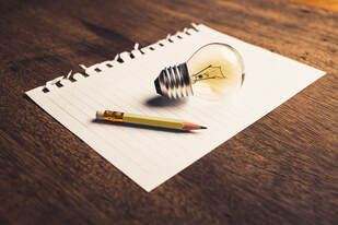 Picture of a light bulb drawn in 3D on a piece of paper